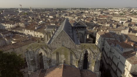 Drone-back-view-of-Saint-Roch-church-in-Montpellier,-France.-Early-morning
